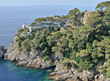 Lighthouse on the rocky coast of the promontory of Portofino. 