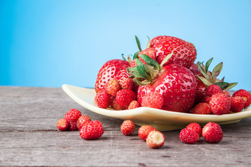 Wild strawberries on a wooden table natural background