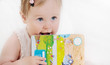 portrait of cute smart baby girl with book in hands