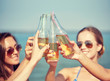 © Syda Productions - close up of happy young women with drinks on beach