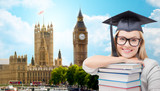 Fototapeta Big Ben - student in trencher cap with books over london