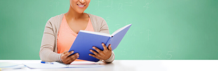 Poster - afro american student girl reading book at school