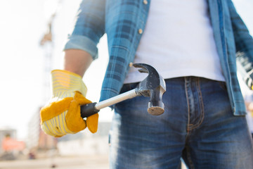 Sticker - close up of builder hand in glove holding hammer