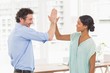 © WavebreakmediaMicro - Casual businessman and woman high fiving