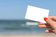 © radub85 - Girl Hand Holding Blank White Card On Beach In Summer