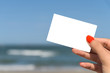 © radub85 - Girl Hand Holding Blank White Card On Beach In Summer