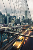 Fototapeta Mosty linowy / wiszący - Taxi cab crossing the Brooklyn Bridge