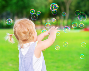 Poster - Baby girl play with soap bubbles