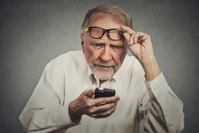 Elderly Man With Glasses Having Trouble Seeing Cell Phone