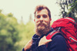 © Syda Productions - smiling man with beard and backpack hiking