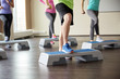 © Syda Productions - group of people flexing legs on step platforms