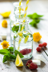 Wall Mural - Lemonade with fresh lemon on wooden background