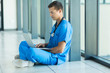 © michaeljung - medical doctor sitting on hospital floor