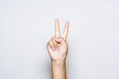 Boy raising two fingers up on hand it is shows peace strength fight or victory symbol and letter V in sign language on white background.
