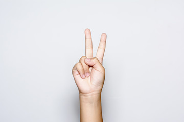 boy raising two fingers up on hand it is shows peace strength fight or victory symbol and letter v i