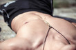 © IgorKireev - Muscular young sexy man lies outdoors