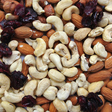 Close-up Of A Pile Of Various Nuts - Almonds, Cashews And Hazelnuts, And Dried Cranberries. Concept Of Clean/healthy Eating; Organic, Unprocessed Food; Paleo Diet.