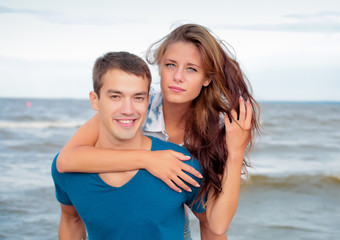 Couple of a young lovers on the beach having dating