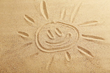 Drawing sun on beach sand