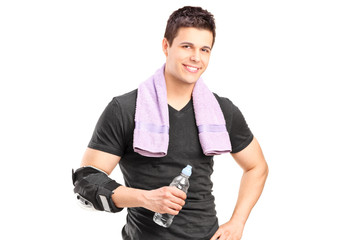 Poster - Sporty man holding a water bottle after exercise