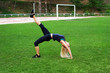 © Victoria - Beautiful sport woman doing stretching fitness. Оn the green grass in the stadium