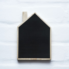 Wall Mural - House shaped wooden sign with place for text. Mock up