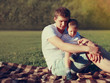 © guas - Portrait of happy father and son child together resting outdoors