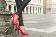 Woman In Black Leather Pants And Red High Heel Shoes