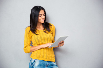 Smiling young woman using tablet computer
