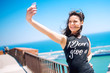 © aboutmomentsimages - Loving to take pictures of herself, girl smiling and being happy while making selfie.