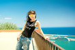 © aboutmomentsimages - portrait of attractive funky girl on top of docks, seaside view.