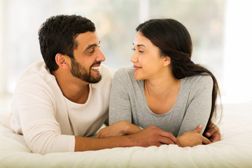 indian couple lying on bed