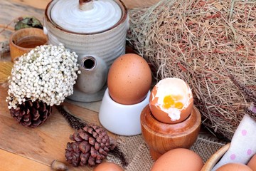 Wall Mural - soft-boiled egg and eggs on wood background