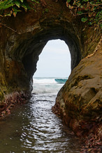 Natural Tunnel In The Rock Dug By Sea Waves