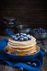 Wall Mural - pancakes with blueberry and powdered sugar in pan