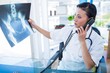© WavebreakmediaMicro - Doctor looking X-rays while having phone call