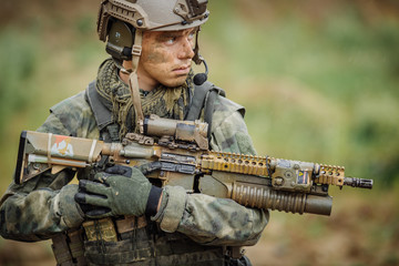 Wall Mural - Portrait of a ranger in the battlefield with a gun