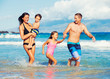 © EpicStockMedia - Happy Family Having Fun at the Beach