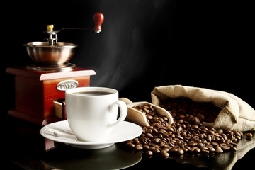 Wall Mural - Cup of coffee with saucer,bag,coffee beans on black