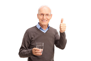 Poster - Senior holding a glass of water and giving a thumb up