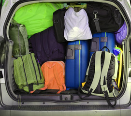 car overloaded with suitcases and duffle bag for family travel