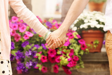 Wall Mural - Young couple holding hands