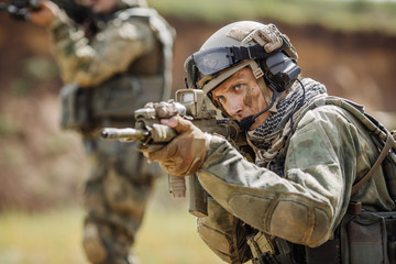 Wall Mural - Portrait of a ranger in the battlefield with a gun