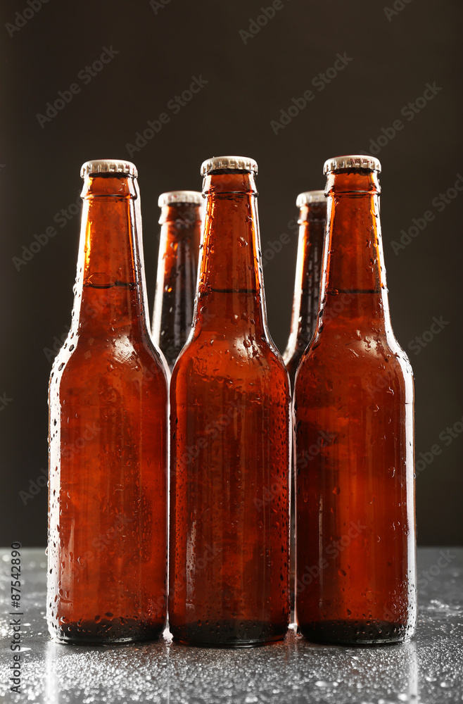 Glass bottles of beer on dark background