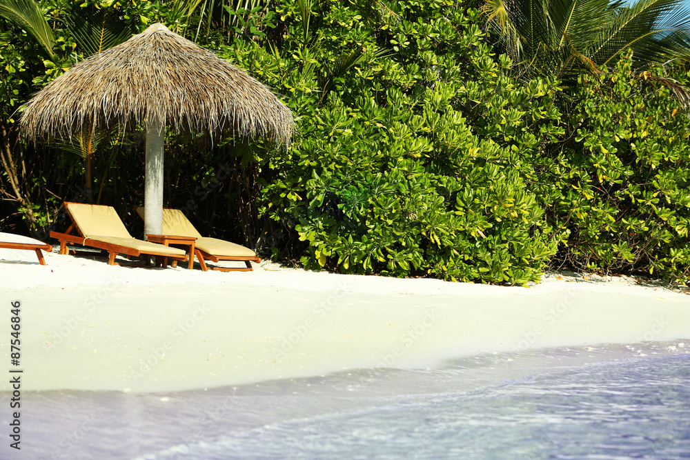 Sunbeds on beautiful beach in resort
