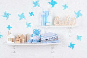 Wall Mural - Baby accessories on shelves close-up