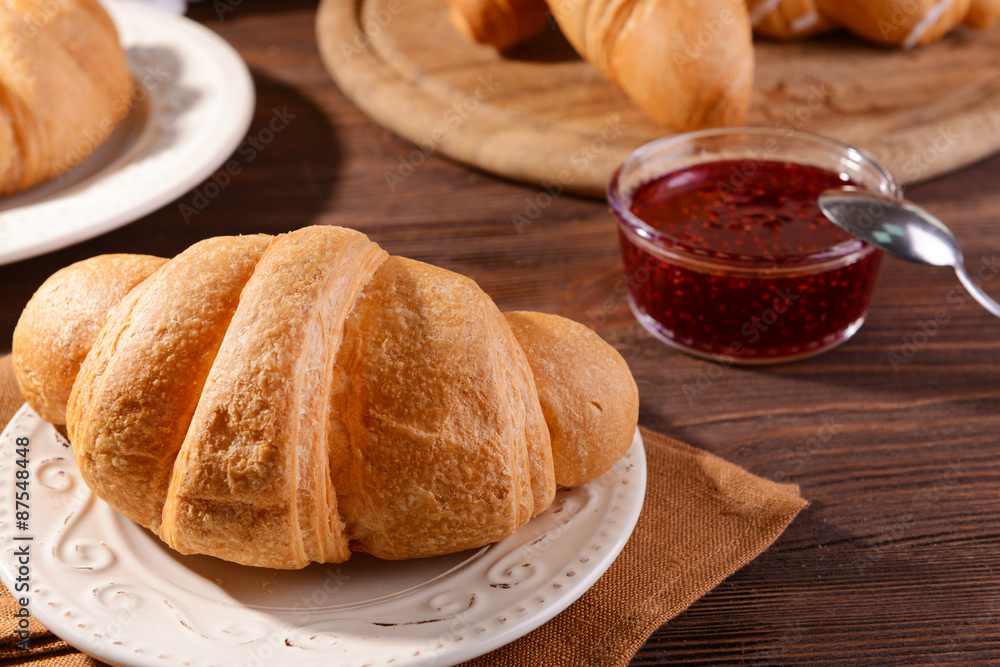 Delicious croissants on plate on table close-up
