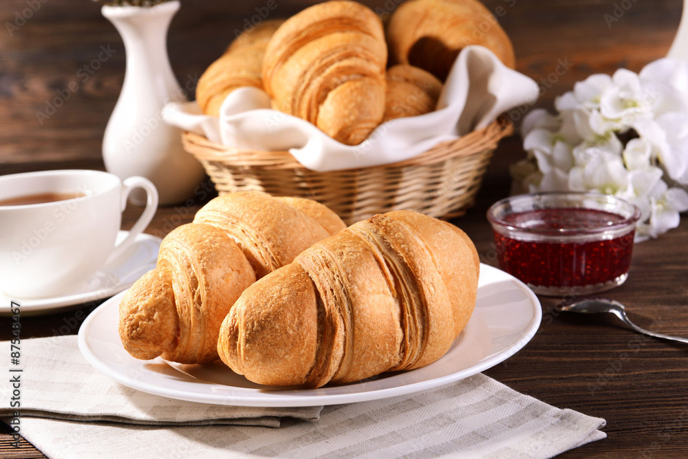 Delicious croissants on plate on table close-up