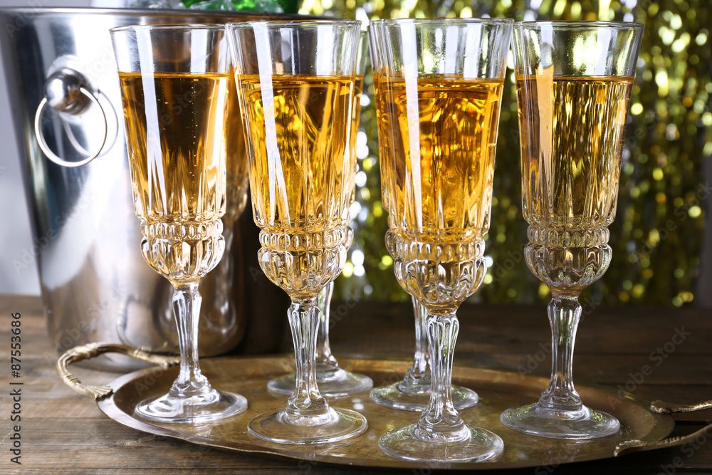 Glasses of champagne on bright background