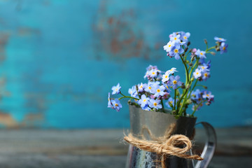 Composition with Forget-me-nots flowers on wooden background